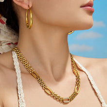 Stainless steel watch link necklace in gold tone worn on model