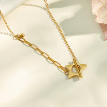 Close-up detail of a gold star T-bar necklace in stainless steel
