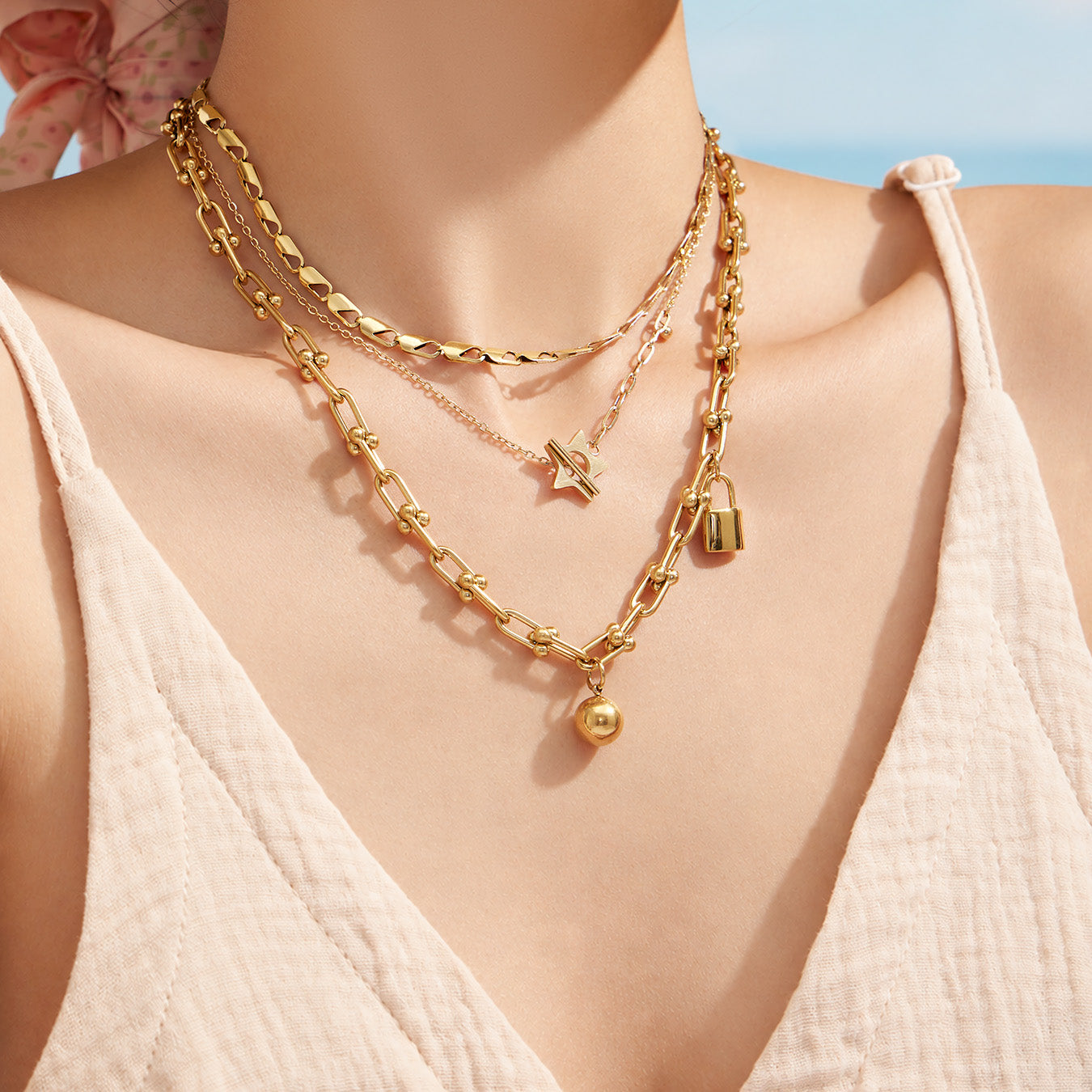 Layered styling of a gold star OT clasp necklace for women's jewelry collections