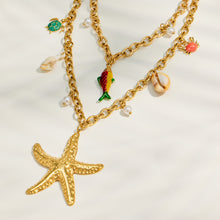 Starfish, shell and fish charm necklace with gold chain and faux pearl accents