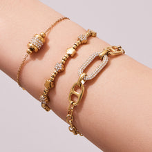 Model stacking multiple 316L Stainless Steel 18K Gold PVD star bead bracelets, layered waterproof style