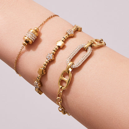 Model stacking multiple 316L Stainless Steel 18K Gold PVD star bead bracelets, layered waterproof style