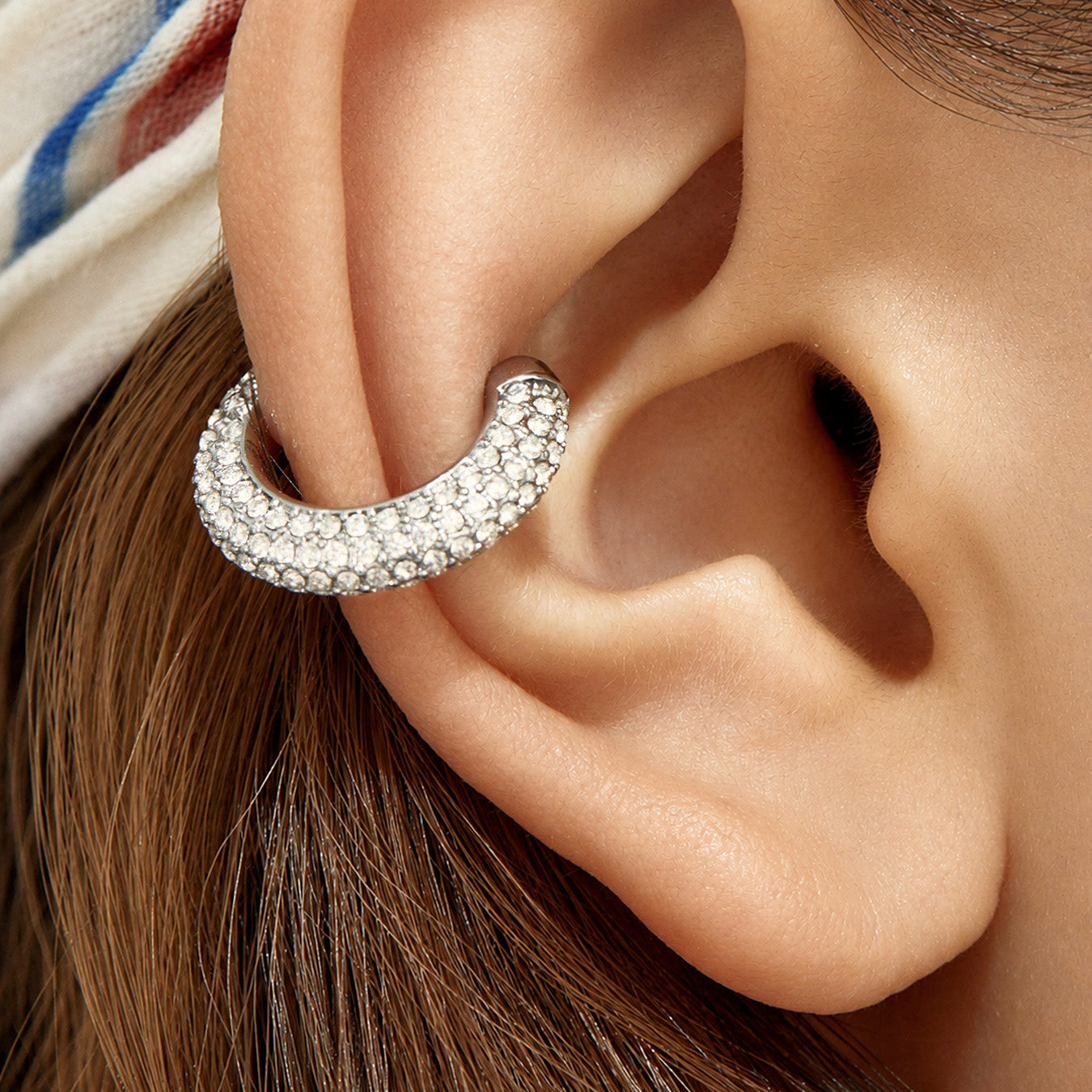 Model wearing a polished steel ear cuff with clear cubic zirconia accents