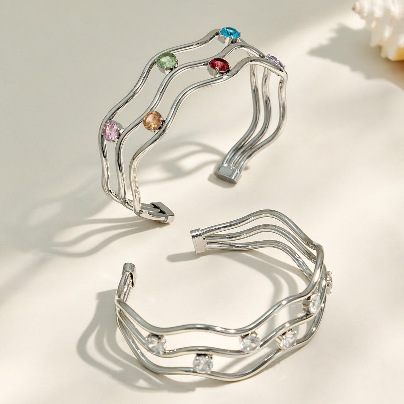 Polished steel three-layer open bangle with clear cubic zirconia accents