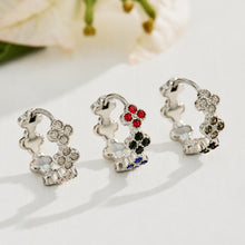 Steel four-leaf clover earrings displayed with white, multicolor and black cubic zirconia