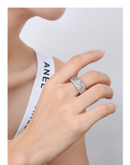 Model wearing steel croissant ribbed dome ring with wide band design for wholesale boutique jewelry buyers