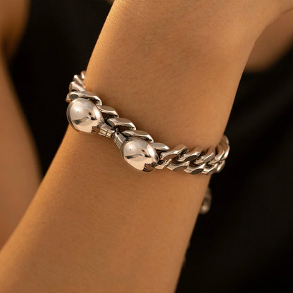 Steel Cuban chain bracelet worn on wrist with polished stainless steel links for everyday unisex jewelry