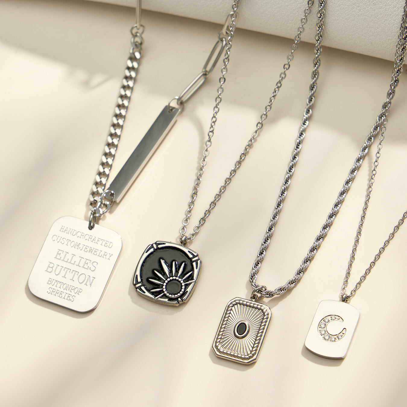 Polished steel geometric tag, black enamel and crescent moon pendant necklaces