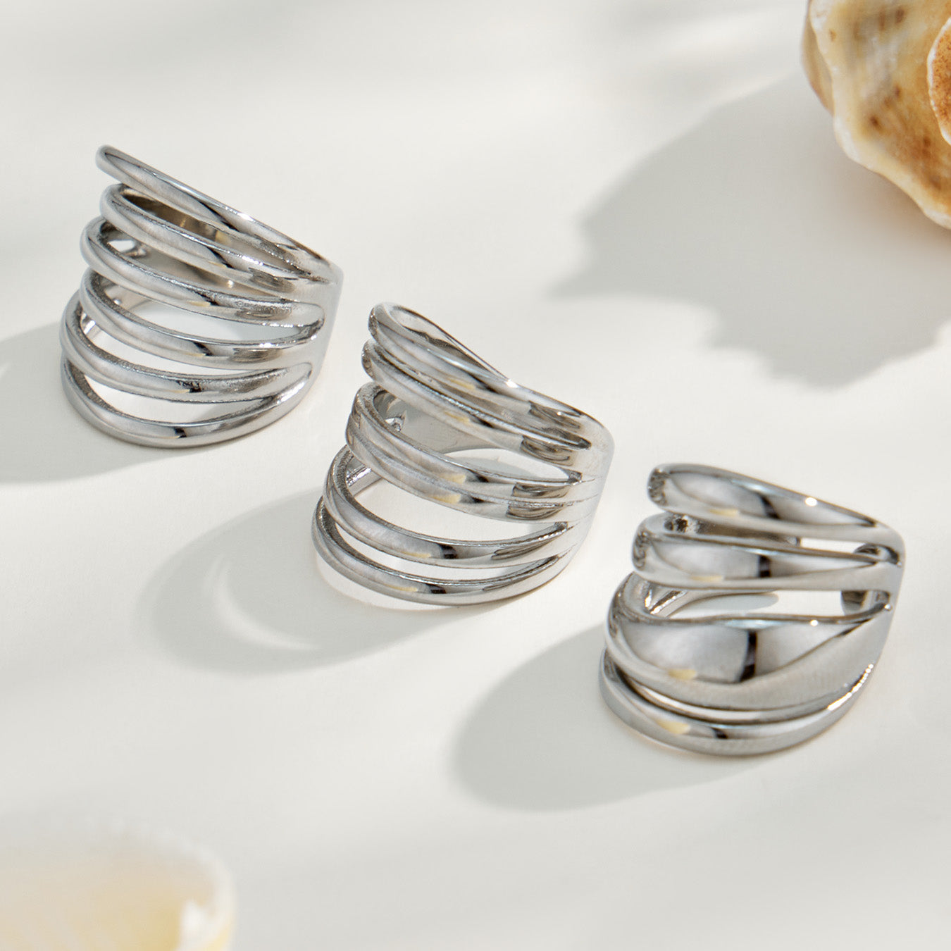 Three steel tone 316L stainless steel irregular open rings in different multi-band styles