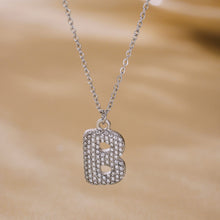 Steel letter B iced out initial necklace with zircon pave pendant and polished chain close up
