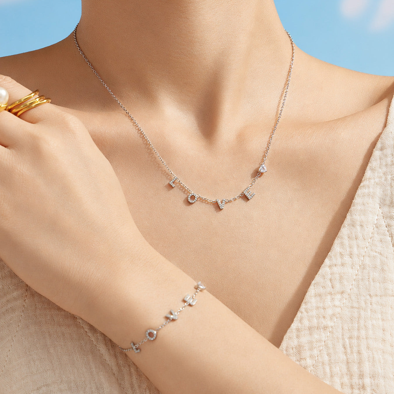 Model wearing a polished steel LOVE letter zircon pendant necklace