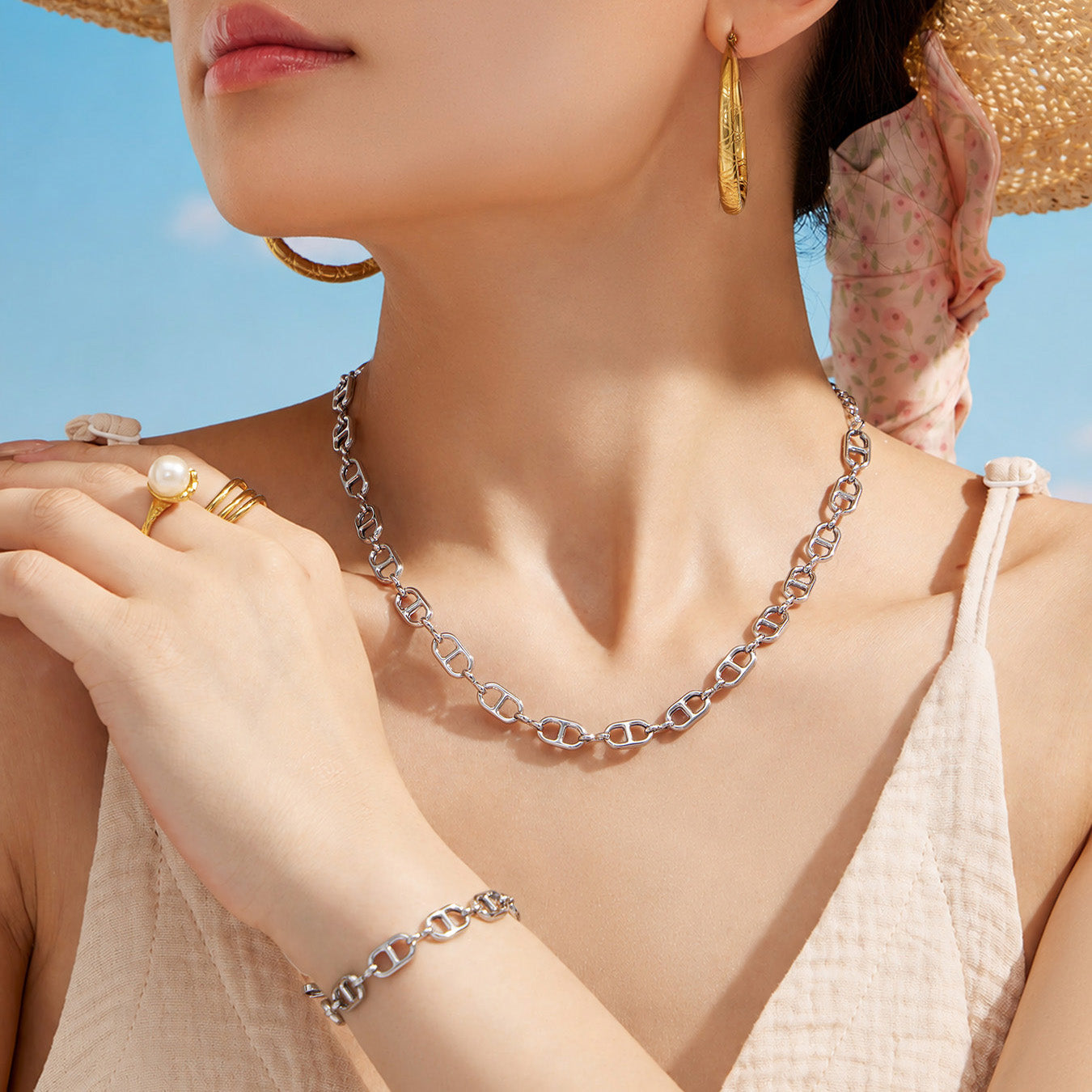 Model wearing a polished steel mariner link necklace and coordinating bracelet