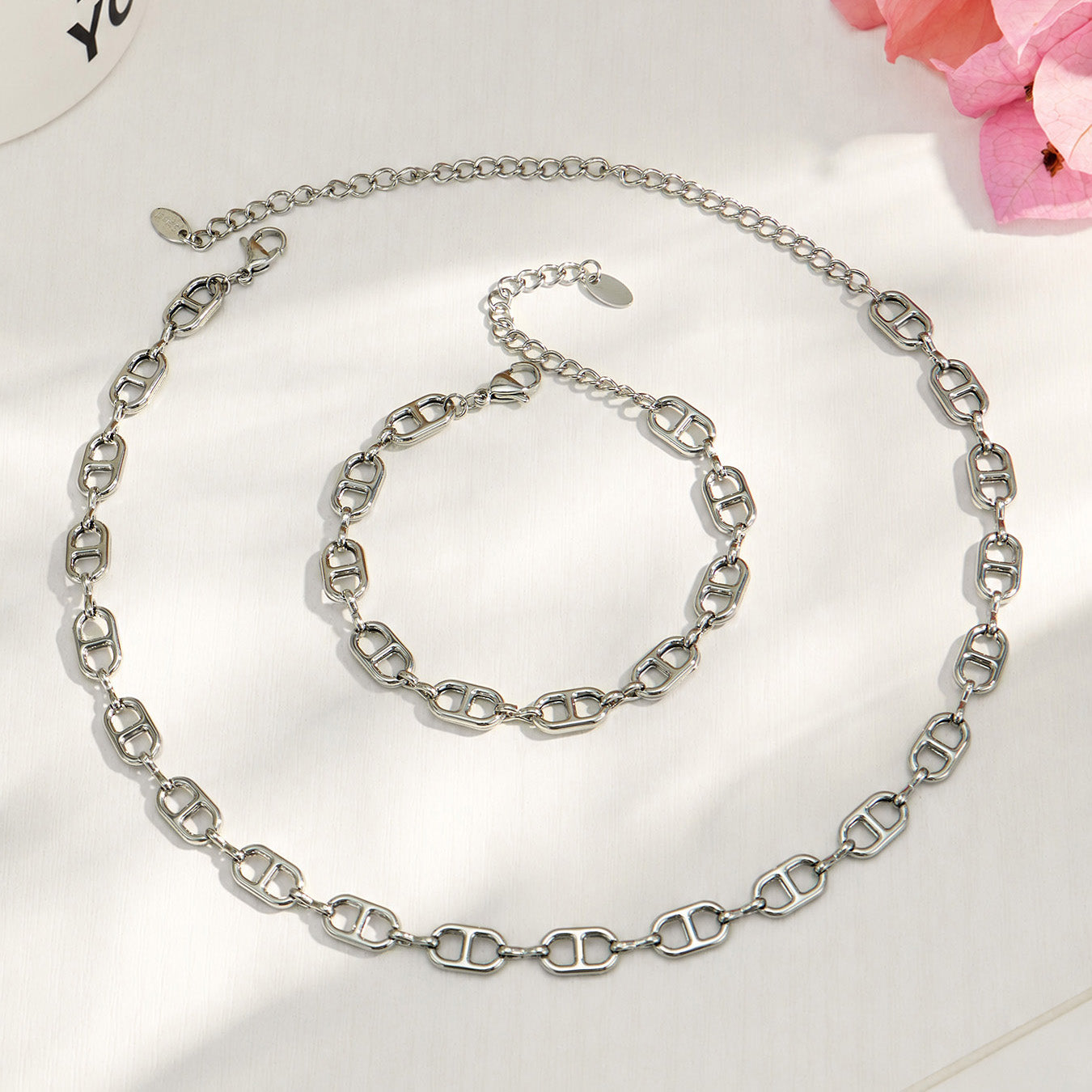 Polished steel mariner link necklace and bracelet displayed together on white