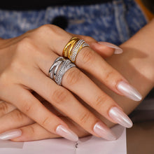 Close-up of a polished steel multi-row cubic zirconia ring worn on the hand