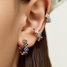 Model wearing steel multicolor cubic zirconia four-leaf clover huggie earrings