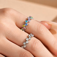 Model wearing a steel-tone multicolor cubic zirconia wide band statement ring