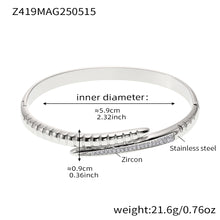 Steel-tone pink zircon nail bangle with a 5.9 cm inner diameter and 21.6 g weight