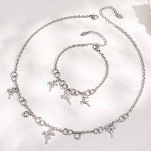 Polished steel reindeer necklace and coordinating deer charm bracelet displayed together