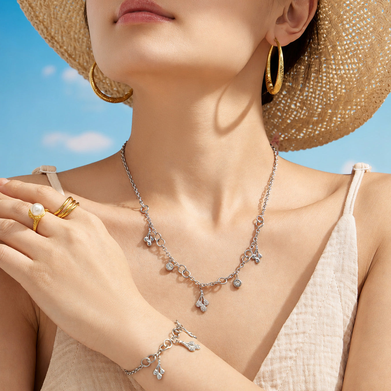 Polished steel teardrop zircon necklace worn by a model in a summer setting