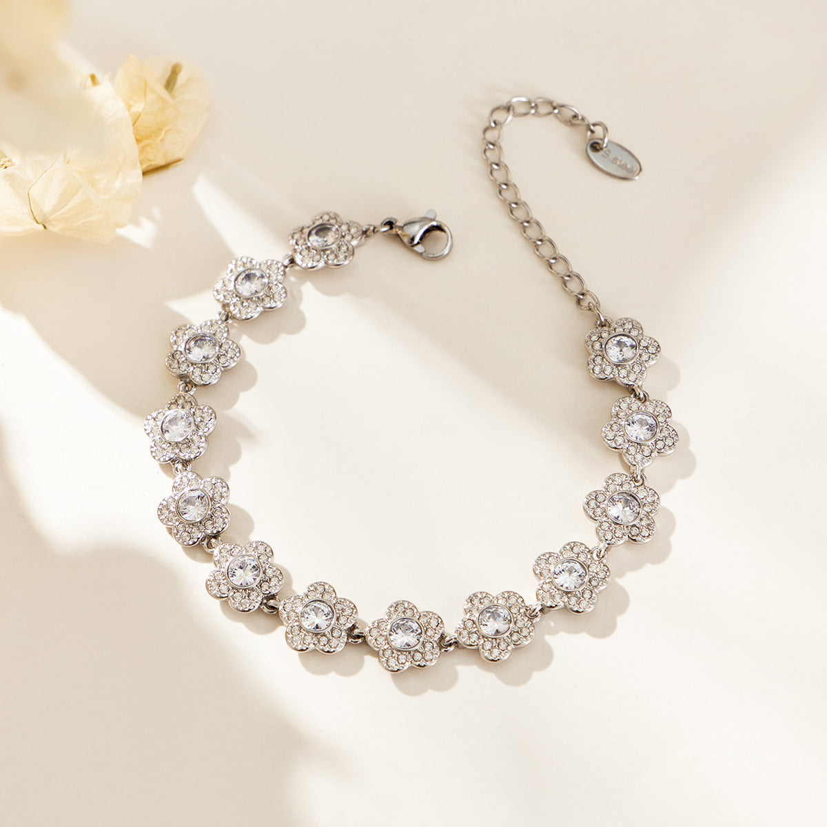 Steel-tone stainless steel flower link bracelet with cubic zirconia accents