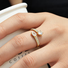 Steel-tone stainless steel open ring with cubic zirconia accents worn on hand