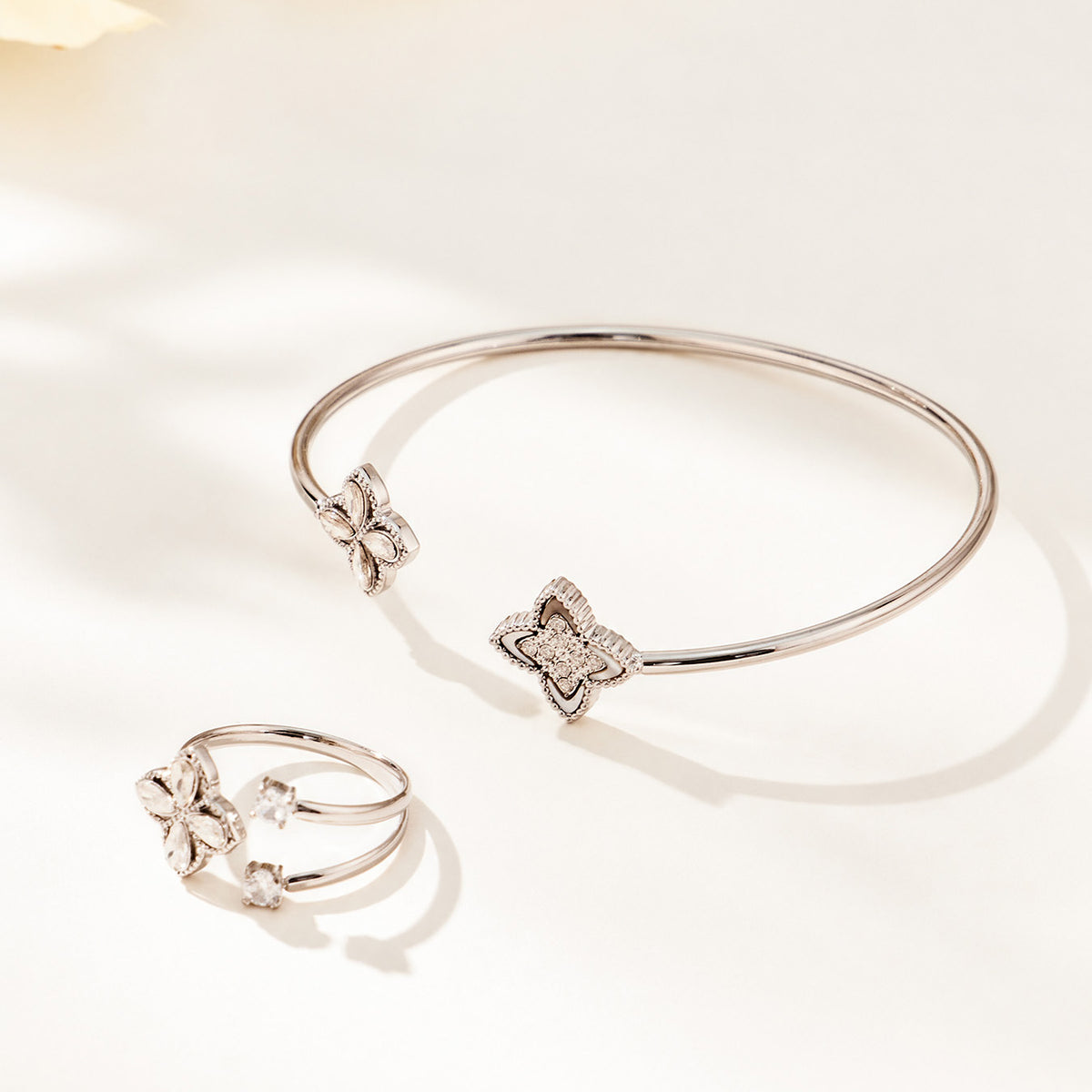 Steel-tone floral open bangle and coordinating flower ring displayed together