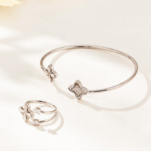 Steel-tone floral open bangle and coordinating flower ring displayed together