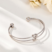 Steel-tone stainless steel open cuff bracelet with minimalist knot design