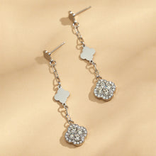 Steel-tone four leaf clover drop earrings with white crystal pavé details