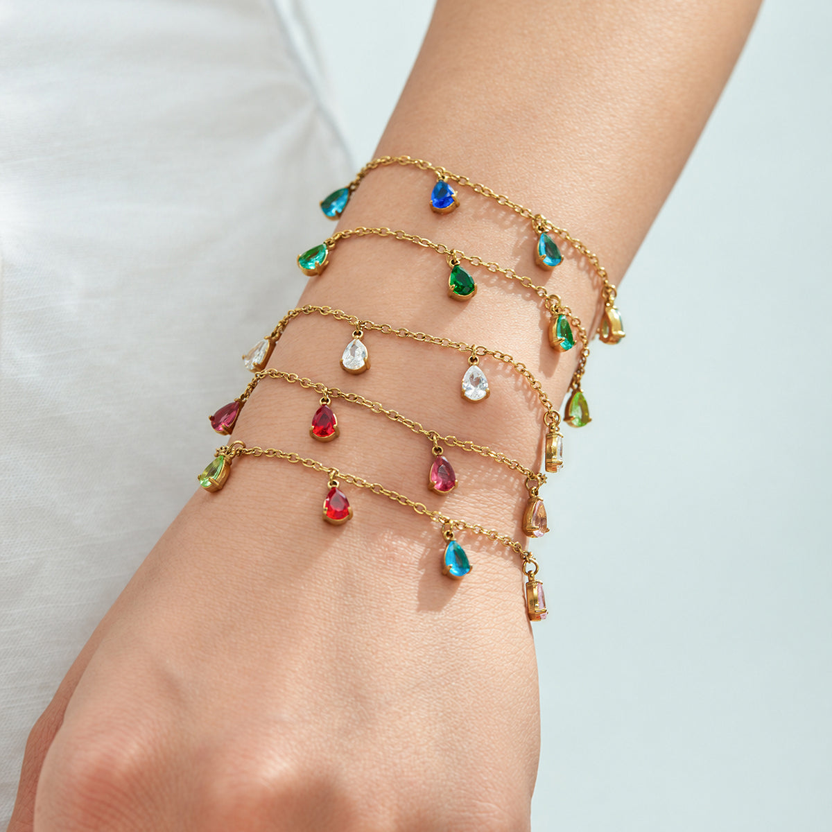Five teardrop zircon bracelet color styles stacked on the wrist