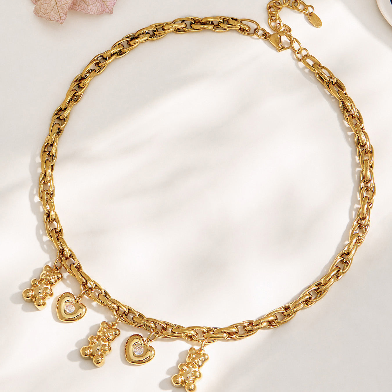 Front view of a model wearing a chunky teddy bear heart charm necklace