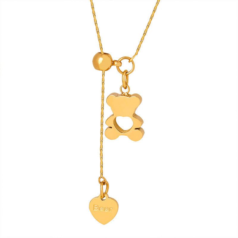 Gold-tone teddy bear pendant necklace in stainless steel with hollow bear design, adjustable drop and heart charm
