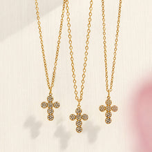 Close-up of three gold cross zircon pendant necklaces in coordinated styles