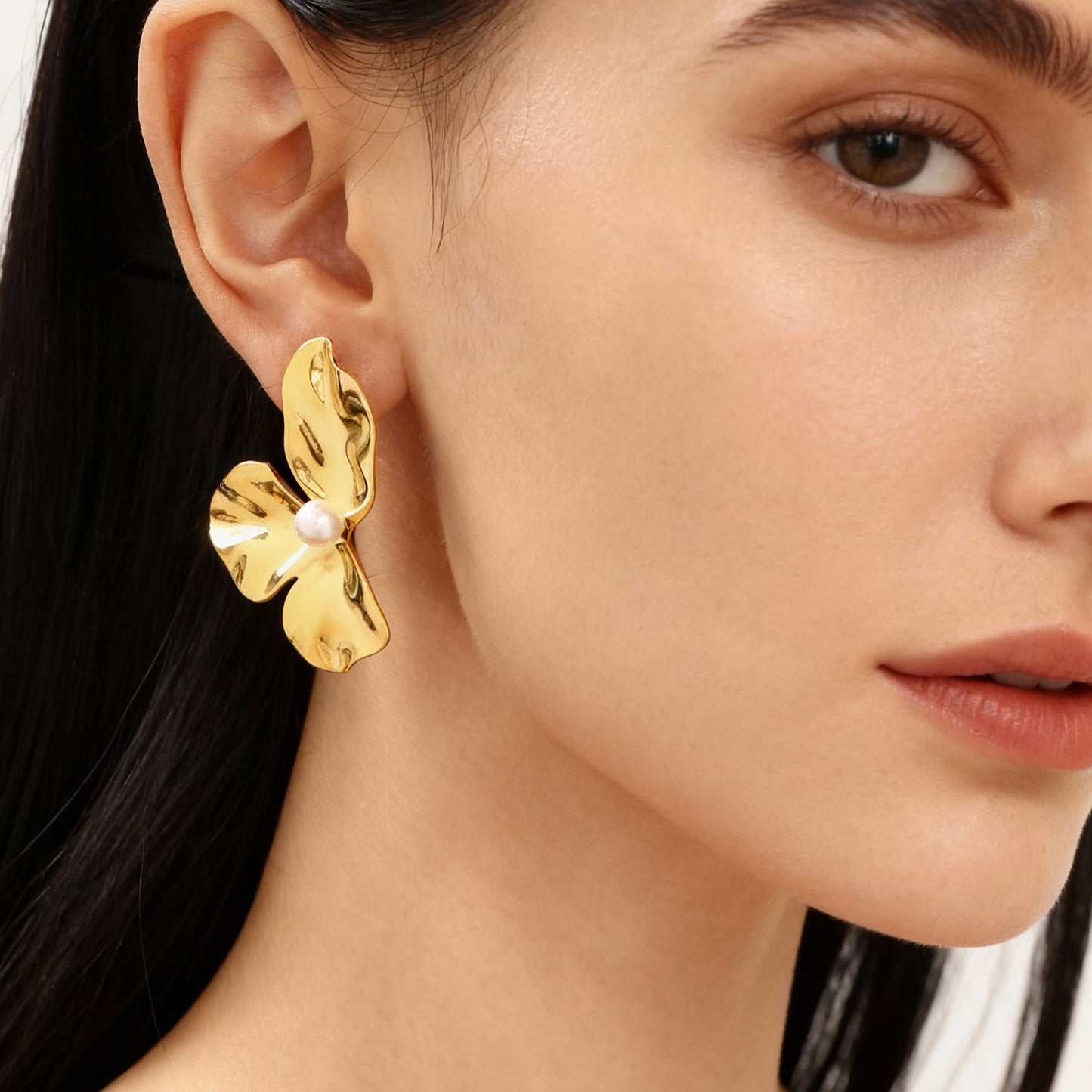 On-ear look of three-petal shell pearl stud earrings in 316L stainless steel