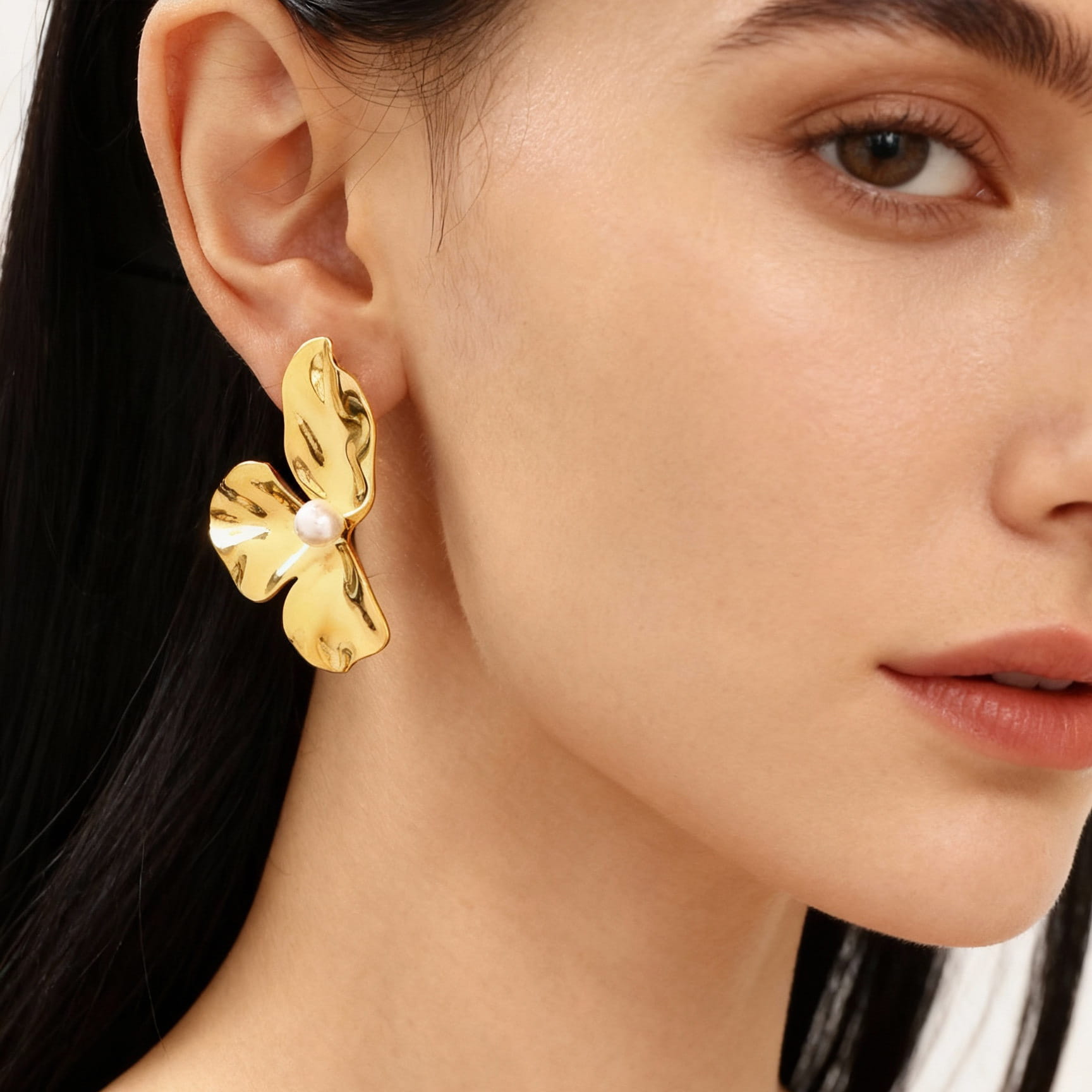 On-ear look of three-petal shell pearl stud earrings in 316L stainless steel