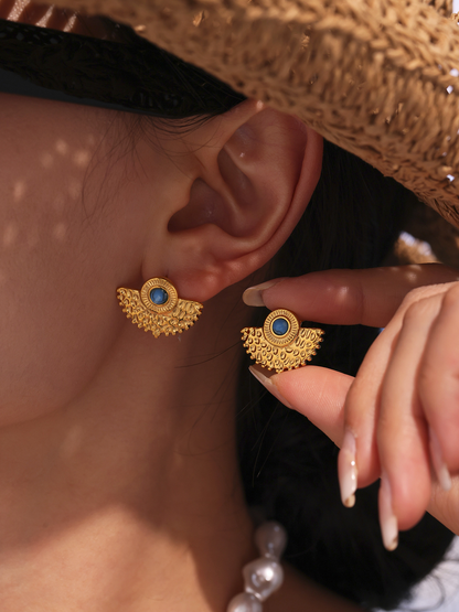 Turquoise peacock fan stud earrings worn with straw hat for resort boutique styling
