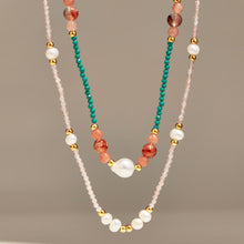 Turquoise and pink natural stone necklaces with freshwater pearl accents on display