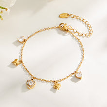 Gold heart zircon charm bracelet with adjustable chain displayed on a light background