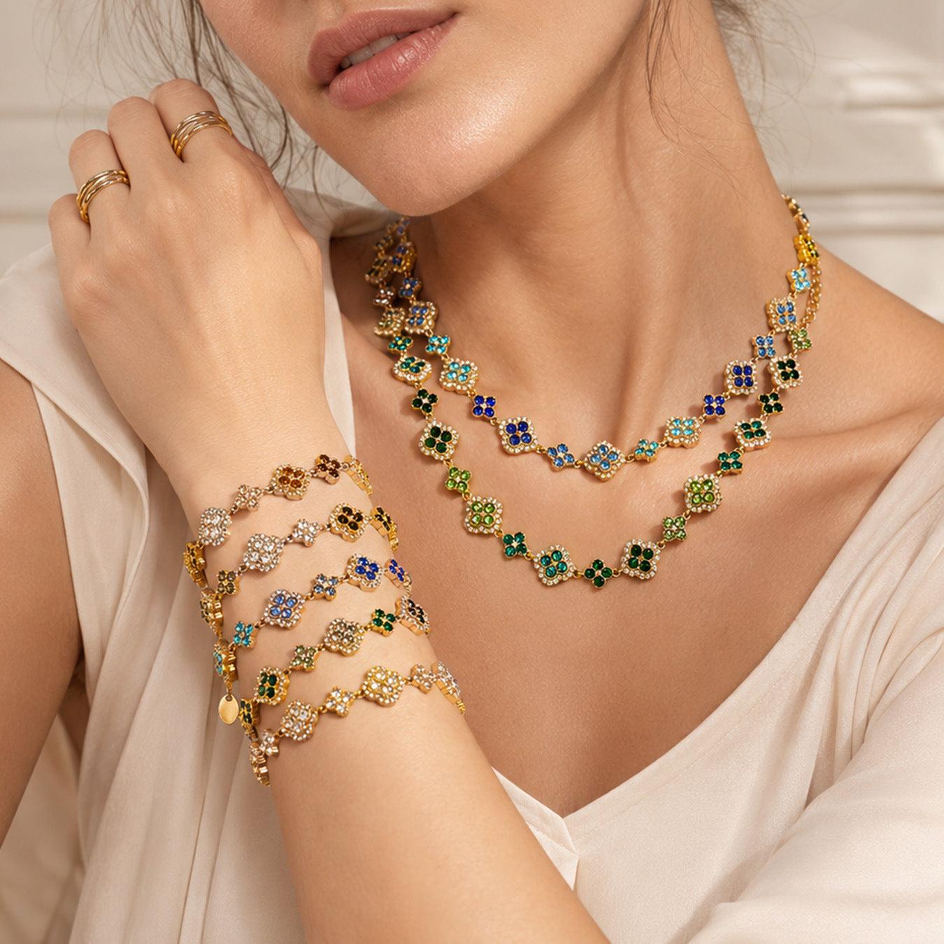 Model wearing 316L stainless steel four leaf clover zircon necklace and bracelet set in 18K gold PVD