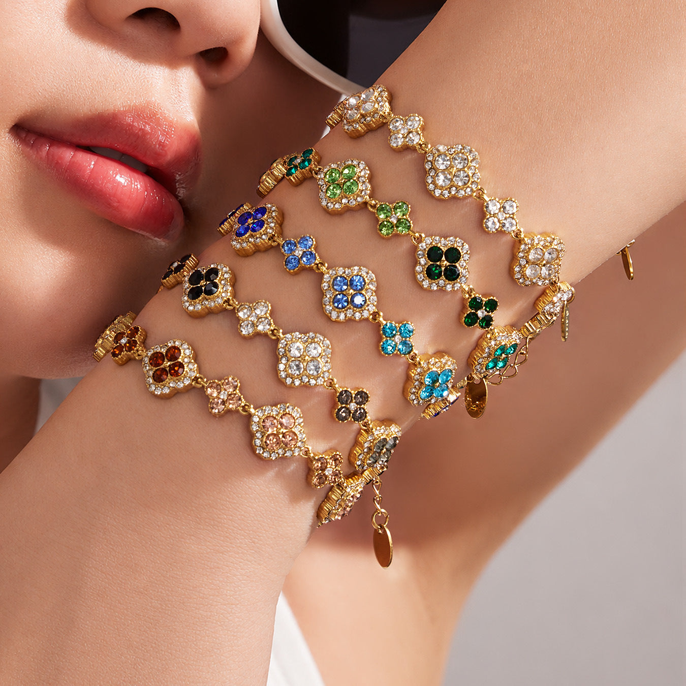 Close up of 18K gold PVD four leaf clover zircon bracelets in multiple crystal colors