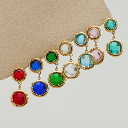Double drop glass stone earrings in assorted colors on display, gold tone setting