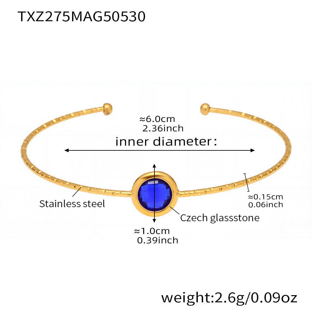 stainless steel open bangle, 18K gold plated, 6.0cm inner diameter, 1.0cm dark blue round faceted Czech glass stone, weight 2.6g