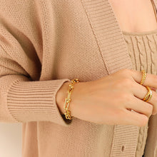 Gold U-link chain bracelet worn as a minimalist everyday accessory