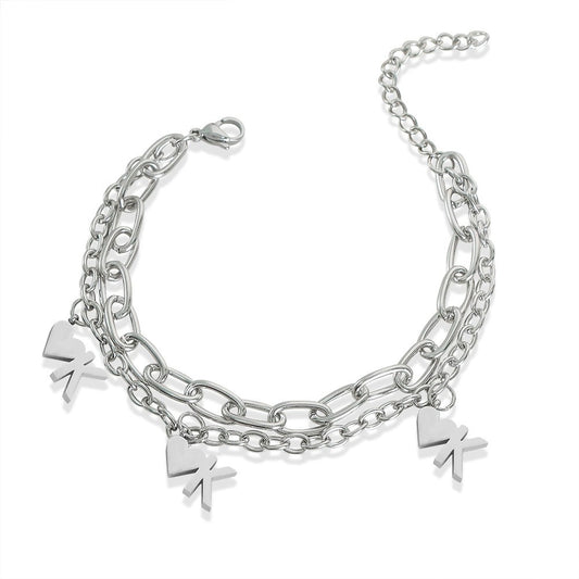 Unisex stainless steel heart chain bracelet worn on wrist with double-layer link chain and silver pendant details