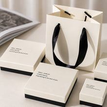 White and black jewelry boxes with matching paper gift bag for wholesale boutique packaging