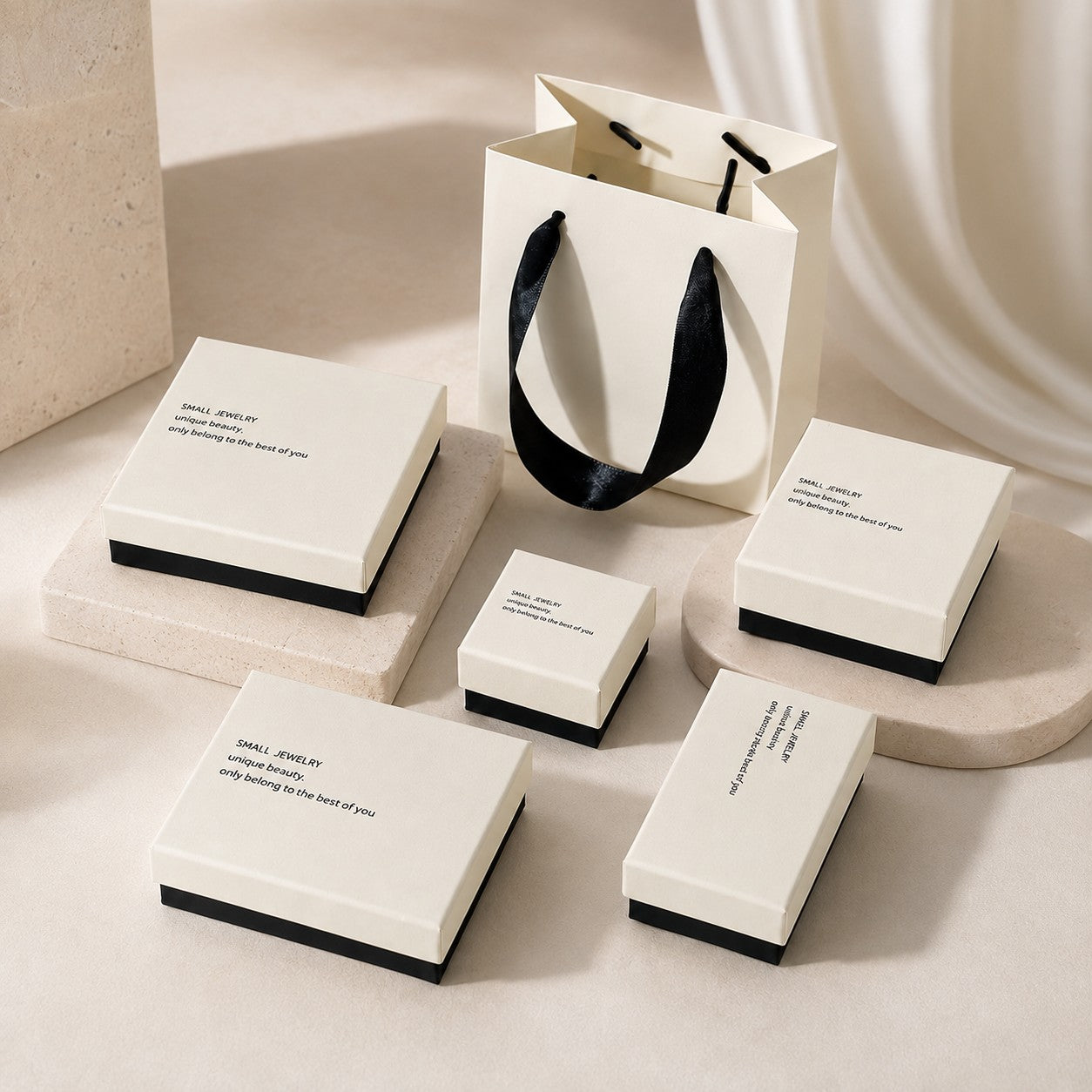 White and black jewelry packaging collection with multiple box sizes and matching gift bag