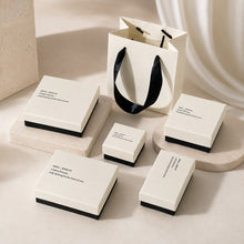 White and black jewelry packaging collection with multiple box sizes and matching gift bag