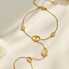 White cat eye hand chain bracelet with geometric D-shaped links on a light background