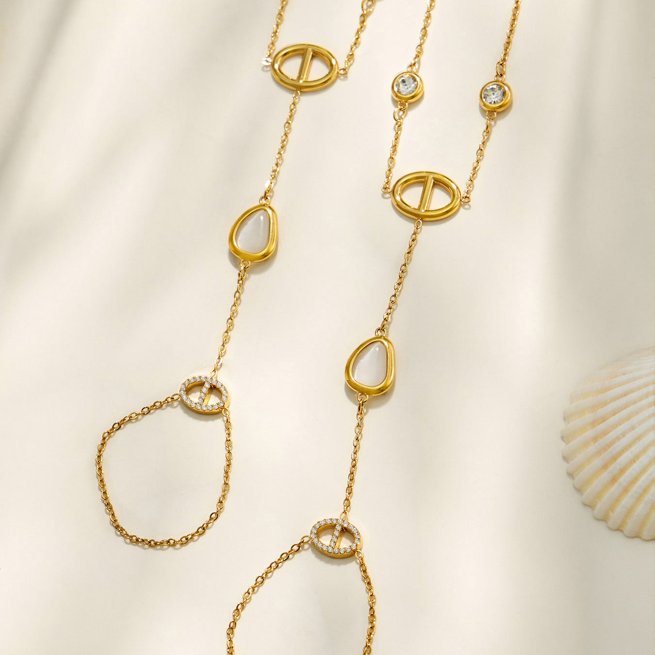 Detail of the wrist-to-finger chains with white cat eye stone accents