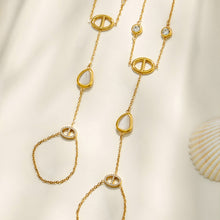 Detail of the wrist-to-finger chains with white cat eye stone accents